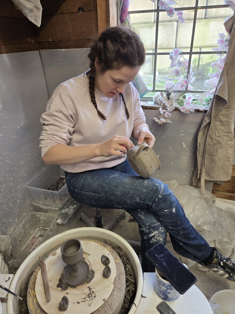 Sara at work trimming a pot